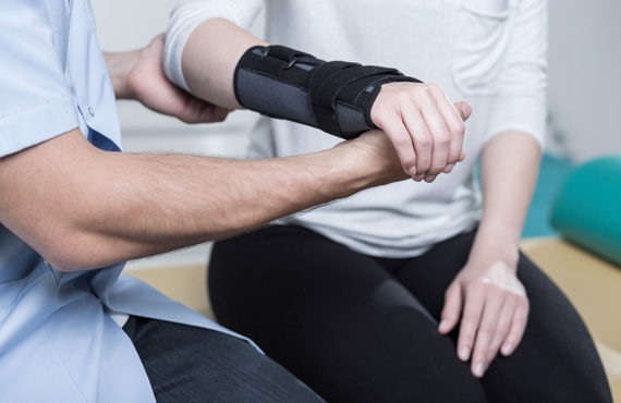 Physiotherapist working on patient's wrist